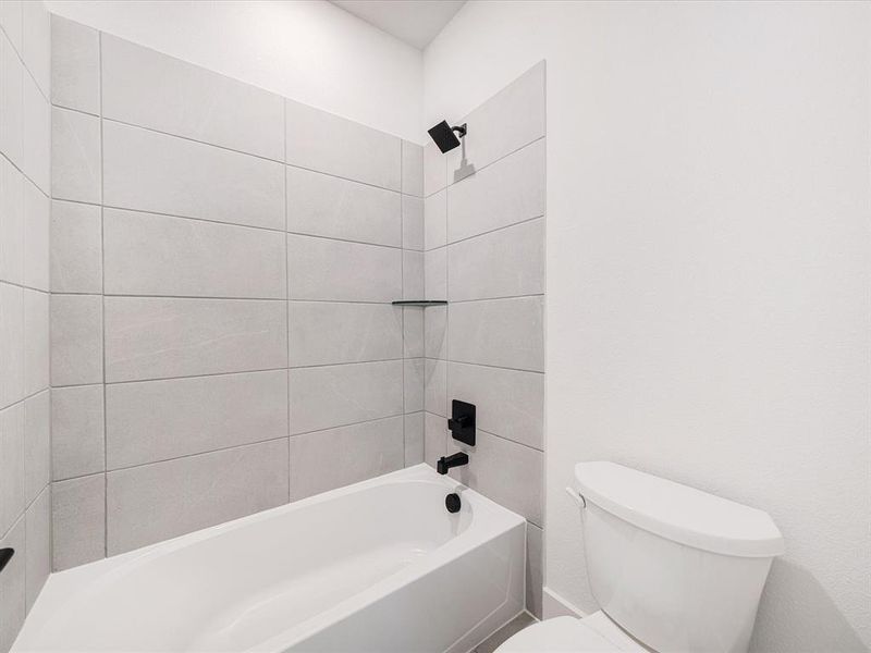 Full bath featuring shower / washtub combination and toilet