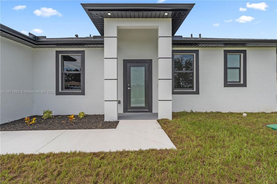Front exterior of a new home in , Lehigh Acres, FL, highlighting curb appeal (Image 15).