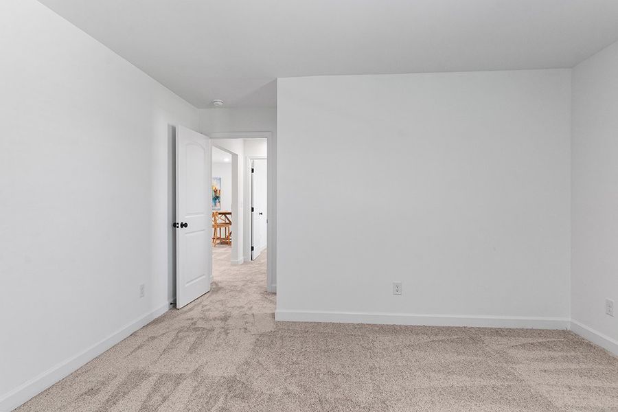 A hallway with white walls.