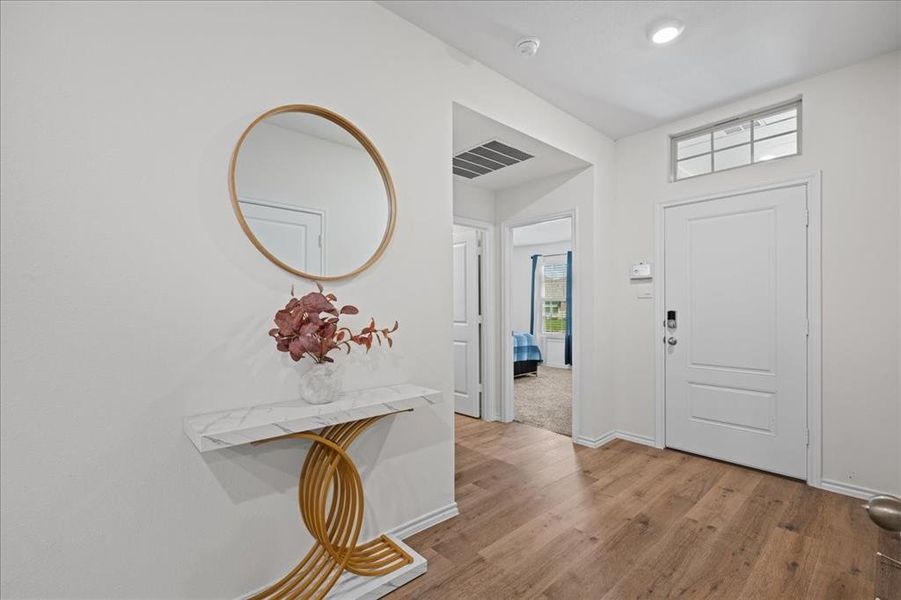 Foyer entrance with light wood-style floors and baseboards Foyer entrance with light wood-style floors and baseboards