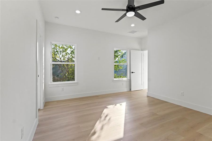 Empty room featuring recessed lighting, light wood-style floors, and a ceiling fan