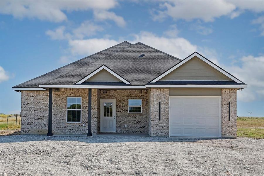 Single story home with an attached garage, brick siding, and roof with shingles Single story home with an attached garage, brick siding, and roof with shingles