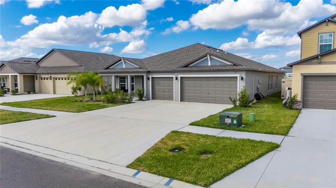 Front exterior of a new home in Balm Grove, Wimauma, FL, highlighting curb appeal (Image 28).