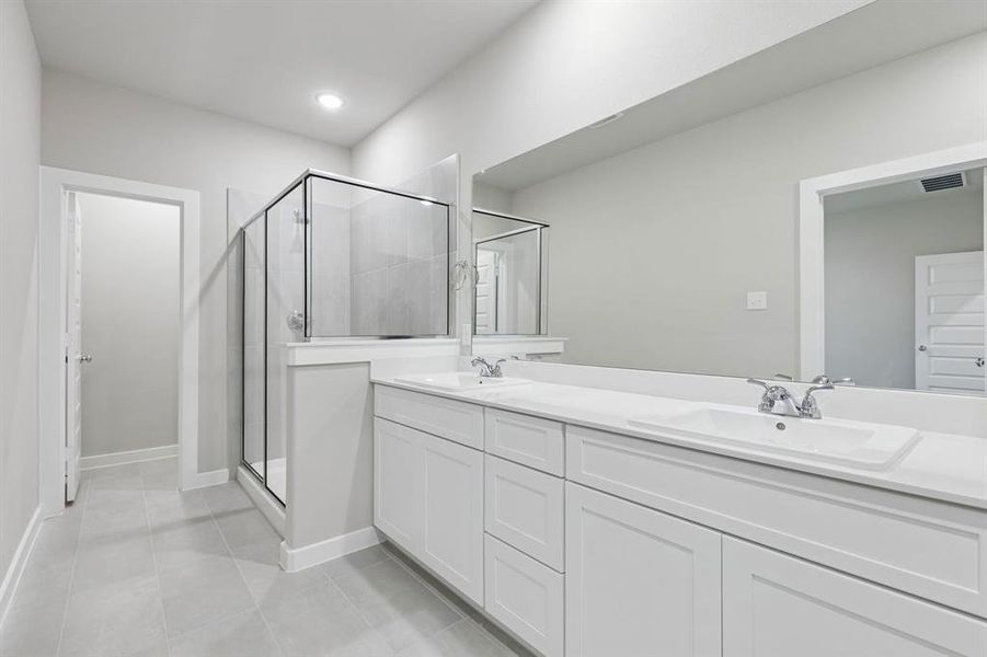 Primary Bathroom in the Holden home plan by Trophy Signature Homes – REPRESENTATIVE PHOTO