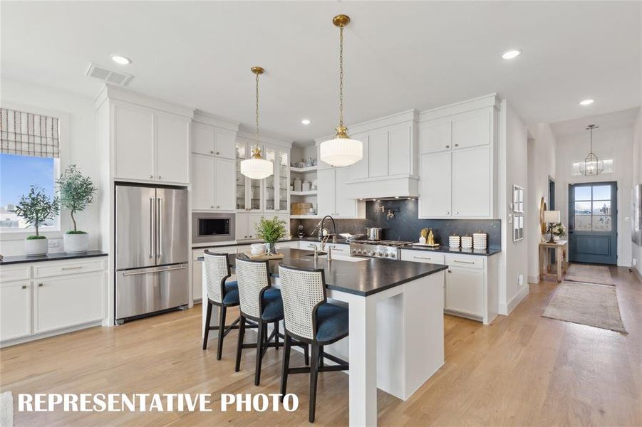 Featuring in wonderful prep and storage spaces, this dream kitchen will inspire your inner chef!  REPRESENTATIVE PHOTO