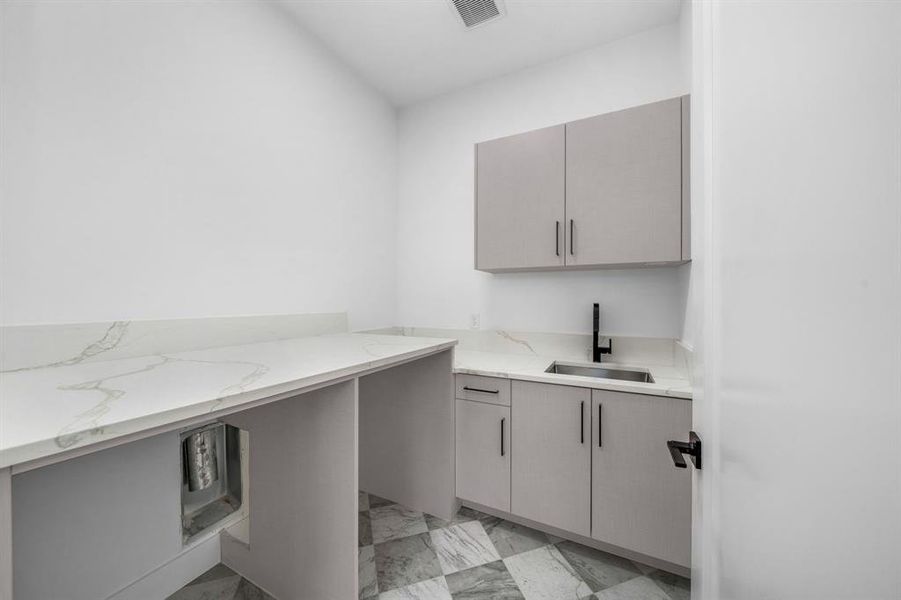 Unfurnished office featuring light marble finish floors and a sink