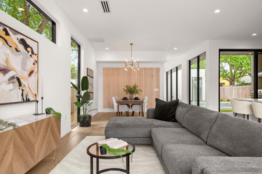 Living area with light wood-type flooring and a chandelier