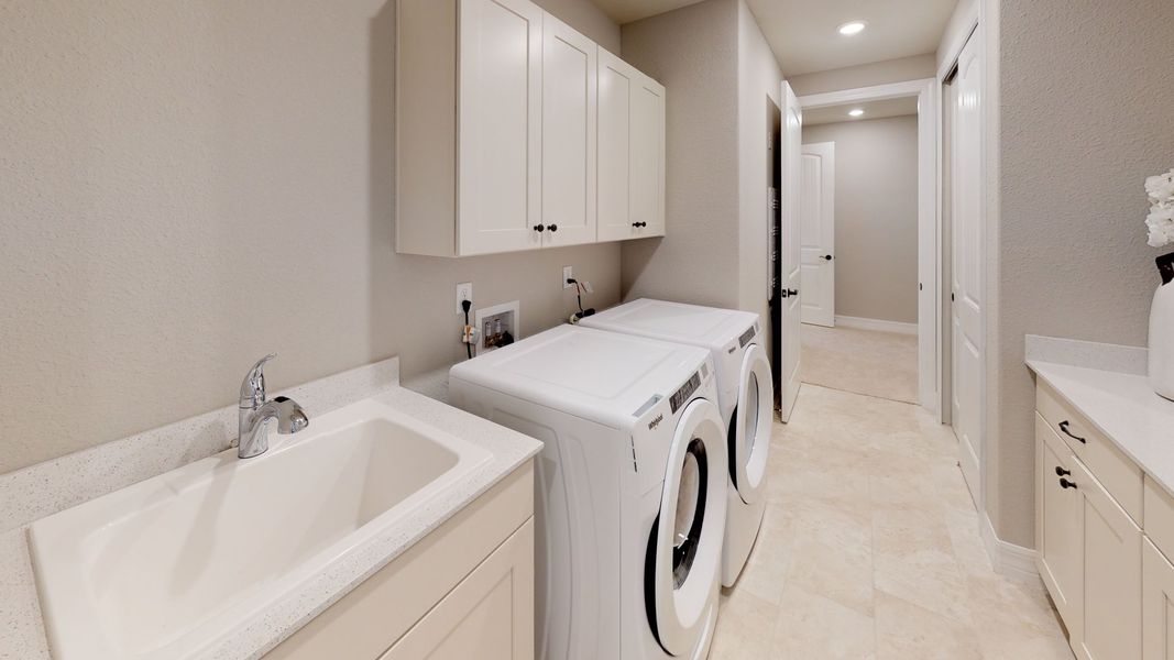 Spacious laundry room with optional sink and additional cabinets - perfect for storage