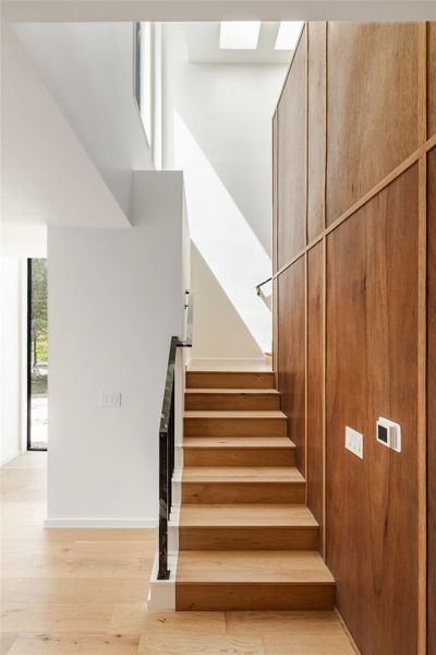 Stairway featuring wood finished floors and baseboards