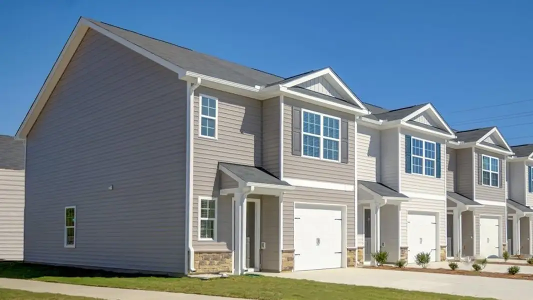 Front exterior of a new home in The Townes at Carter Ridge, Greenville, NC, highlighting curb appeal (Image 2). Front exterior of a new home in The Townes at Carter Ridge, Greenville, NC, highlighting curb appeal (Image 2).
