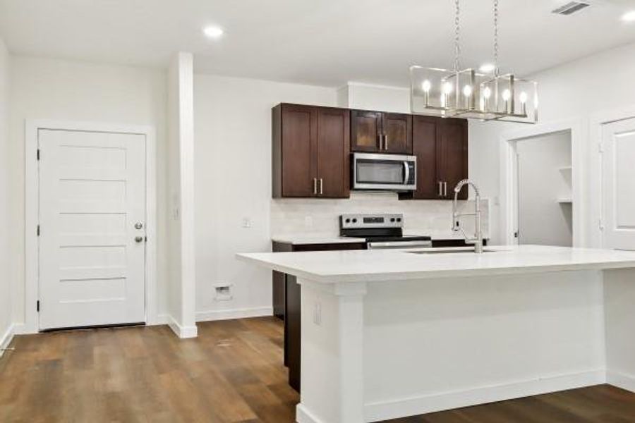 Welcome home to a bright, stylish entrance that flows seamlessly into a modern kitchen, featuring sleek cabinetry, stainless steel appliances, and elegant lighting. Welcome home to a bright, stylish entrance that flows seamlessly into a modern kitchen, featuring sleek cabinetry, stainless steel appliances, and elegant lighting.