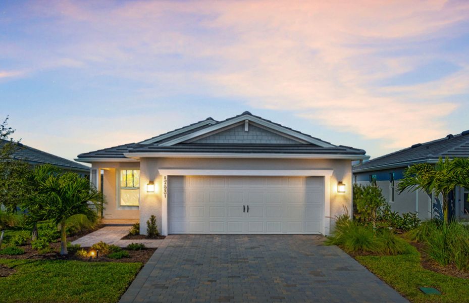 Front exterior of a new home in Del Webb Oak Creek, North Fort Myers, FL, highlighting curb appeal (Image 2). Front exterior of a new home in Del Webb Oak Creek, North Fort Myers, FL, highlighting curb appeal (Image 2).