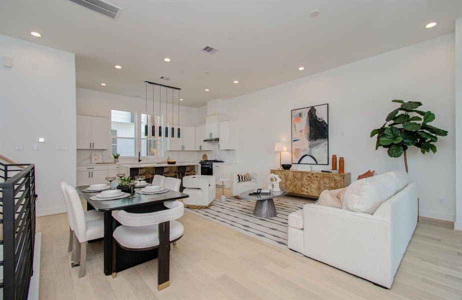 Large open concept living space features European white oak floors and 11 ft ceilings