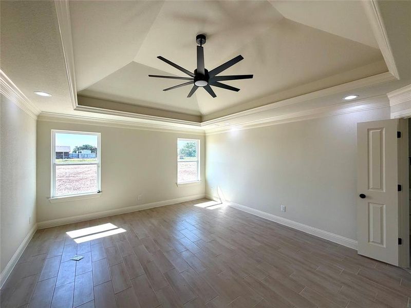 Spare room featuring ceiling fan, wood finish floors, crown molding, and recessed lighting Spare room featuring ceiling fan, wood finish floors, crown molding, and recessed lighting