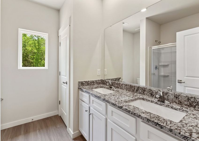 The master bathroom has a glass-enclosed shower
