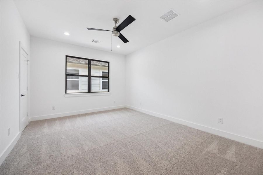 Spacious secondary bedroom with clean lines and soft carpeting, offering a quiet retreat just off the game room. Connects to a stylish Jack-and-Jill bathroom, ideal for guests or siblings sharing the upstairs living space. Spacious secondary bedroom with clean lines and soft carpeting, offering a quiet retreat just off the game room. Connects to a stylish Jack-and-Jill bathroom, ideal for guests or siblings sharing the upstairs living space.