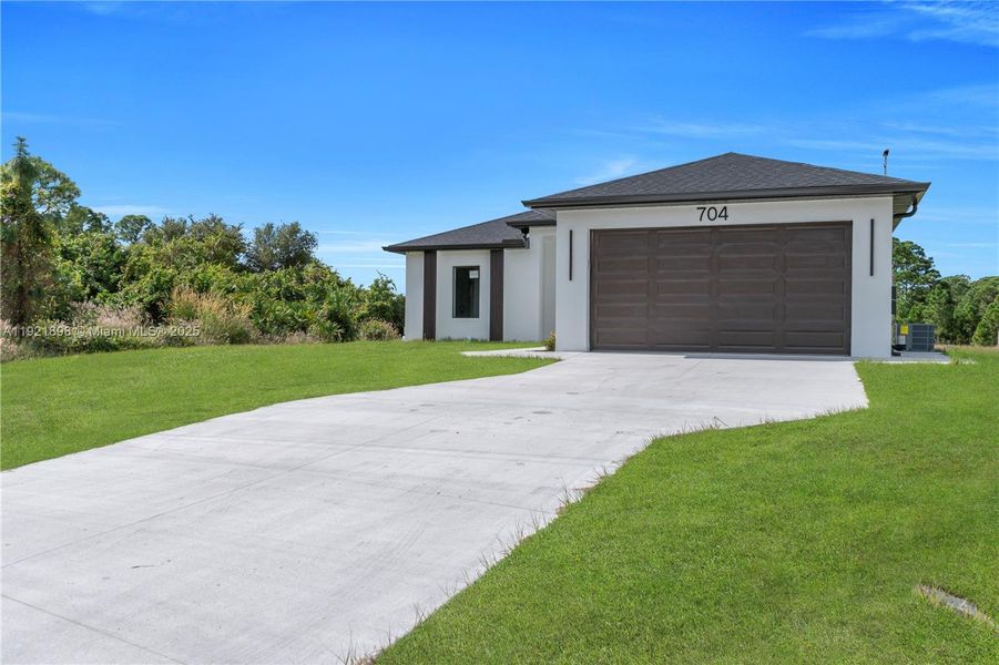 Front exterior of a new home in , Lehigh Acres, FL, highlighting curb appeal (Image 18). Front exterior of a new home in , Lehigh Acres, FL, highlighting curb appeal (Image 18).