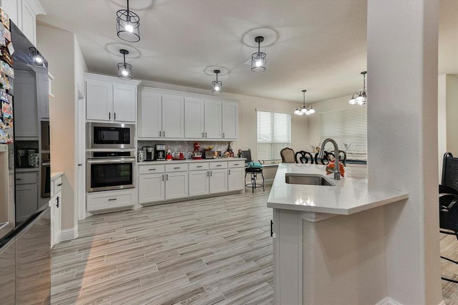 Gourmet kitchen is a chef's dream featuring gas cooktop, built in oven and microwave, upgraded hardware and sleek stainless steel appliances Gourmet kitchen is a chef's dream featuring gas cooktop, built in oven and microwave, upgraded hardware and sleek stainless steel appliances