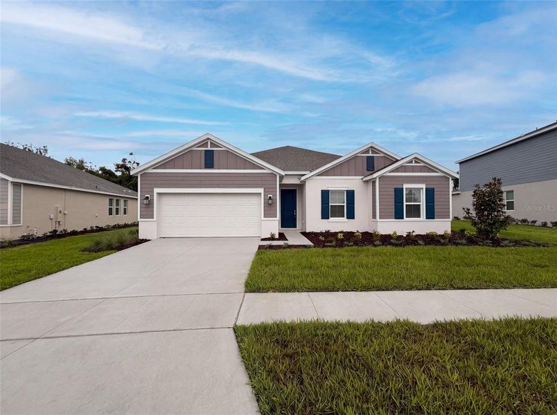 Front exterior of a new home in Meadow Pointe, Groveland, FL, highlighting curb appeal (Image 2).