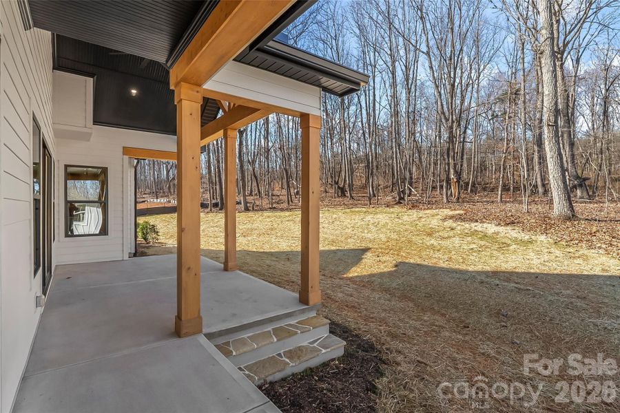 Step outside where a dramatic vaulted ceiling and stained beams creates a true outdoor retreat.  Cozy Carolina nights are best spent on the porch and you'll love this one.