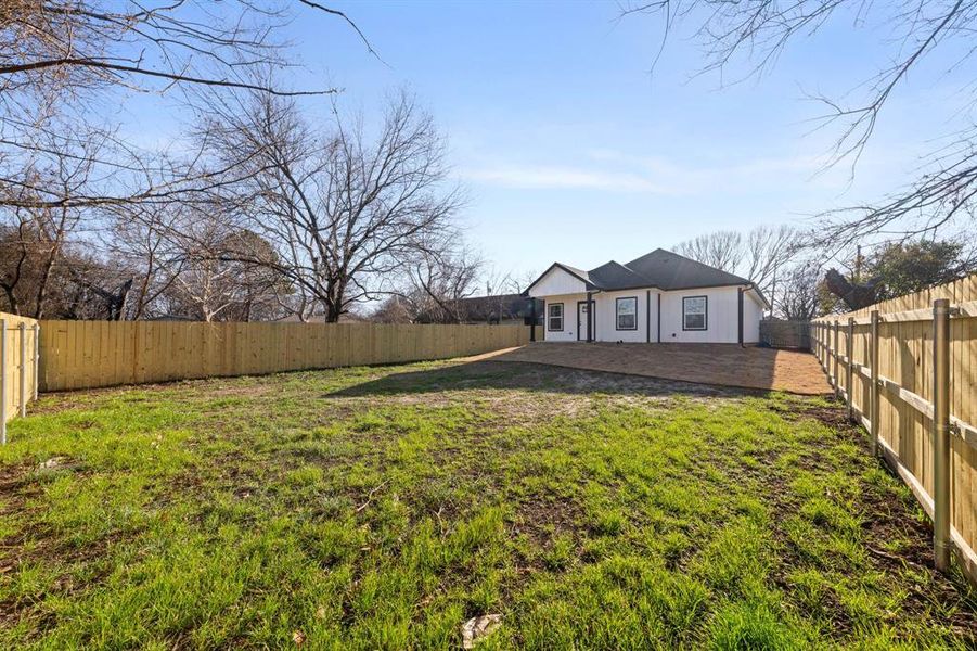Back of property with a fenced backyard and a patio area