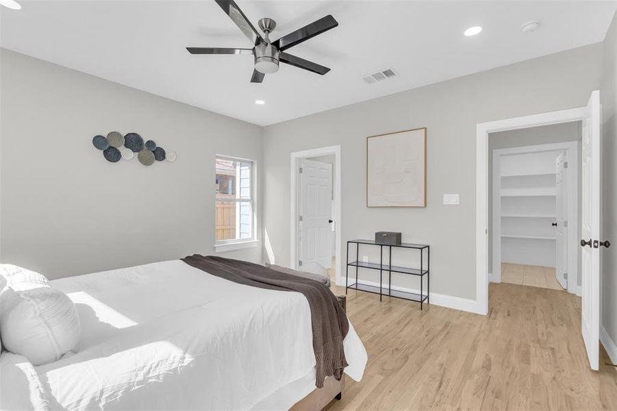 Bedroom with light wood-style flooring, recessed lighting, and a ceiling fan