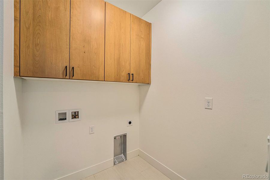 Main level laundry w/cabinets across from primary suite