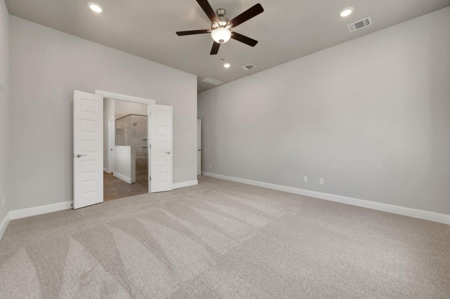 Unfurnished bedroom with carpet, recessed lighting, ceiling fan, and ensuite bathroom