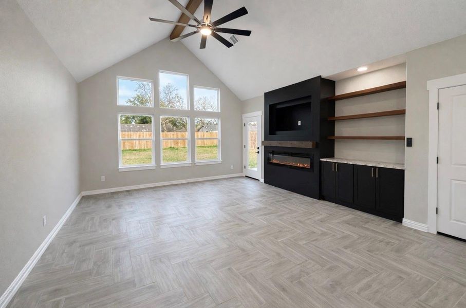 Expansive windows offer stunning views of the spacious yard.