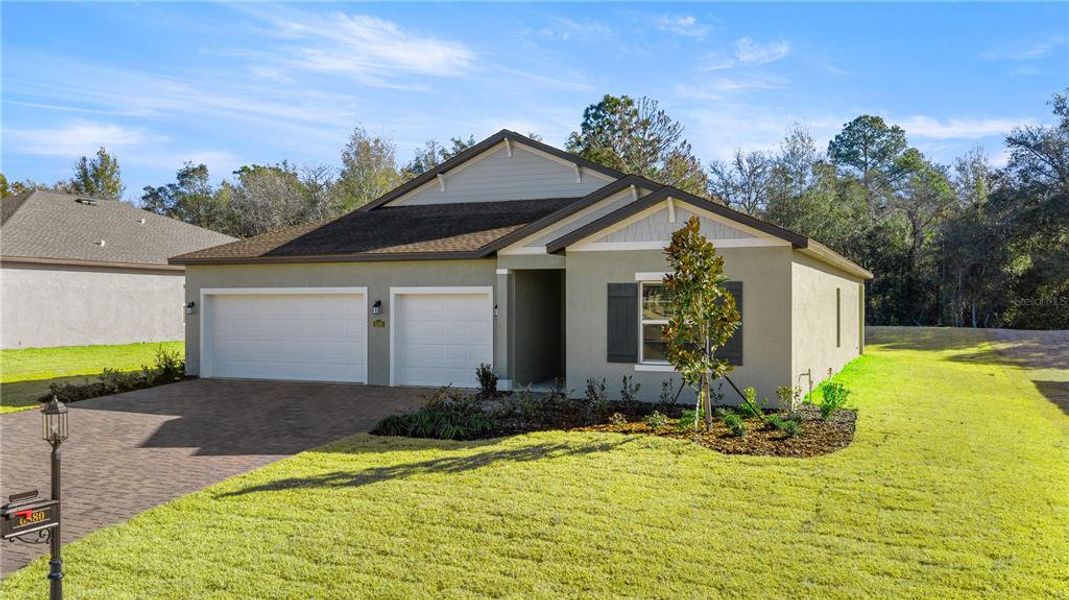 Front exterior of a new home in Juliette Falls, Dunnellon, FL, highlighting curb appeal (Image 2).