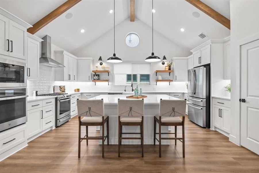 Kitchen with open shelves, white cabinets, high vaulted ceiling, tasteful backsplash, and appliances with stainless steel finishes