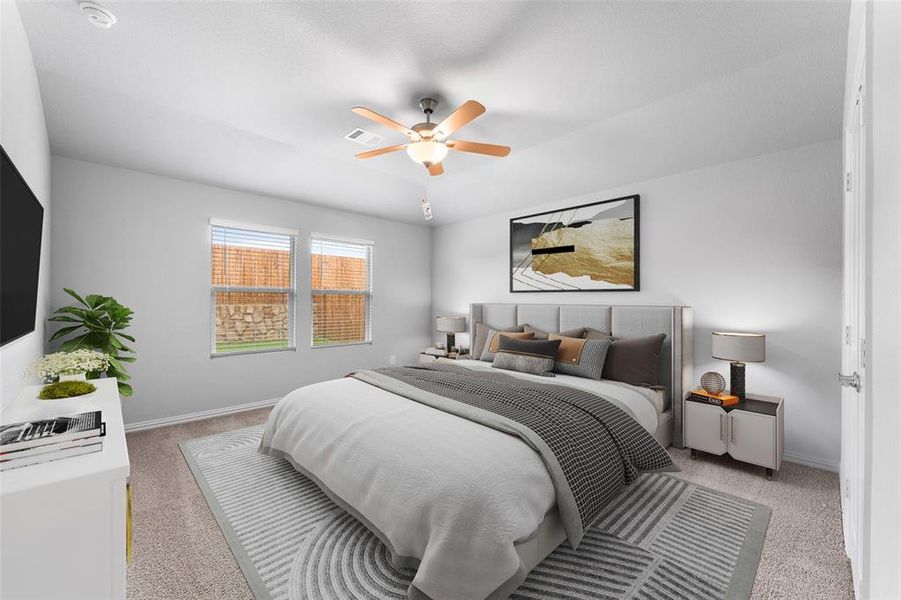 Bedroom featuring light carpet and ceiling fan Bedroom featuring light carpet and ceiling fan