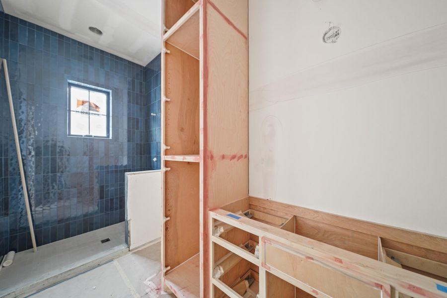 The private en-suite bath features a stylish glazed tile walk-in shower!