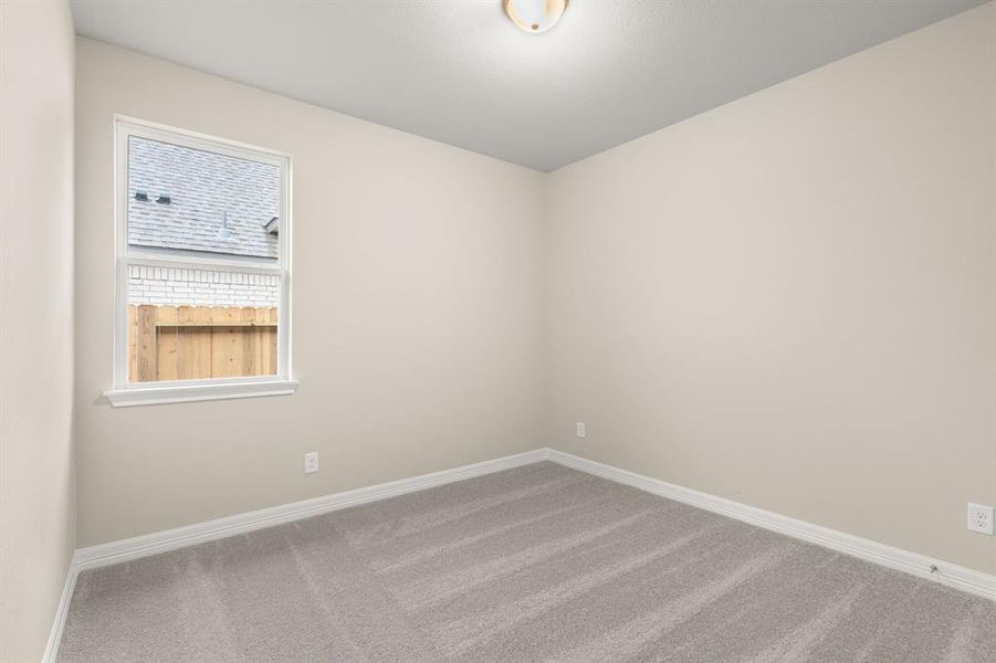 Your secondary bedroom features plush carpet, fresh paint, closet, and a large window that lets in plenty of natural lighting.