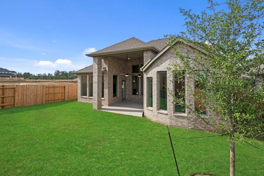 Exterior details and patio area of a home in Wildtree, Magnolia (Image 21).