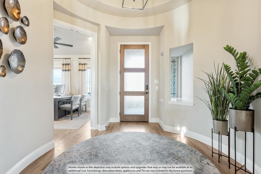 Bright home entryway with wood-and-glass front door, hardwood floors, and round area rug Bright home entryway with wood-and-glass front door, hardwood floors, and round area rug