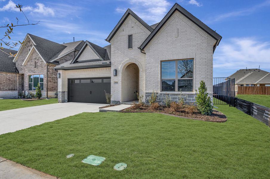 Front exterior of a new home in Tavolo Park Cottages, Fort Worth, TX, highlighting curb appeal (Image 2).