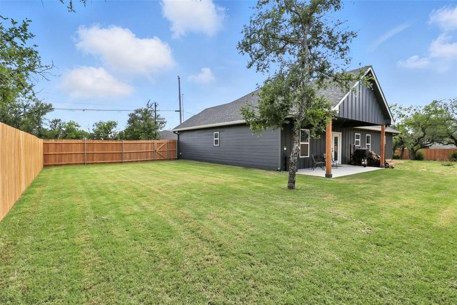 Fenced backyard with a patio area