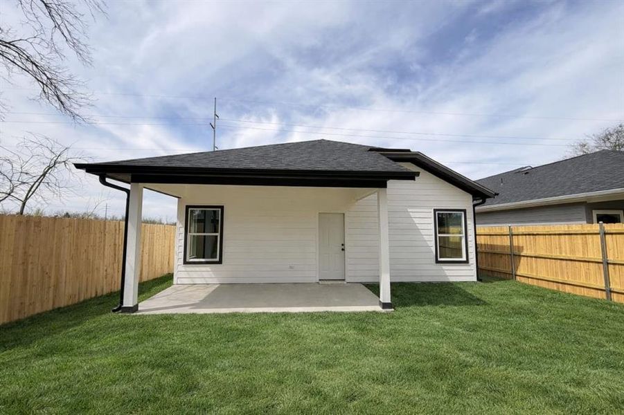 Back of property featuring a patio area, a fenced backyard, and a shingled roof