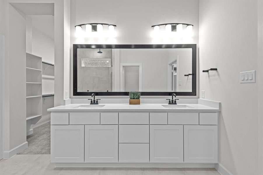 Large vanity with quartz counters and dual sinks at Master