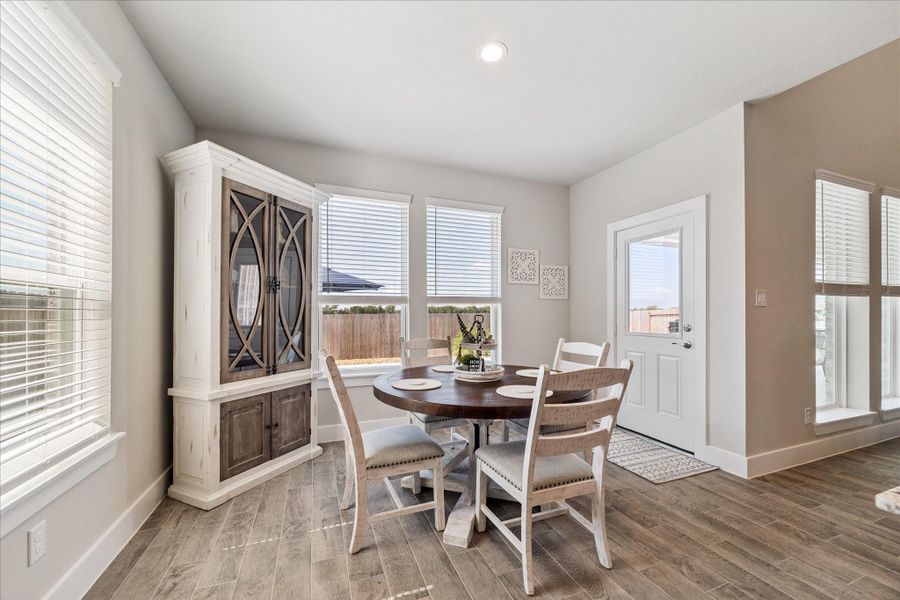 Charming breakfast area with tile, ample natural light, and backyard access. Charming breakfast area with tile, ample natural light, and backyard access.