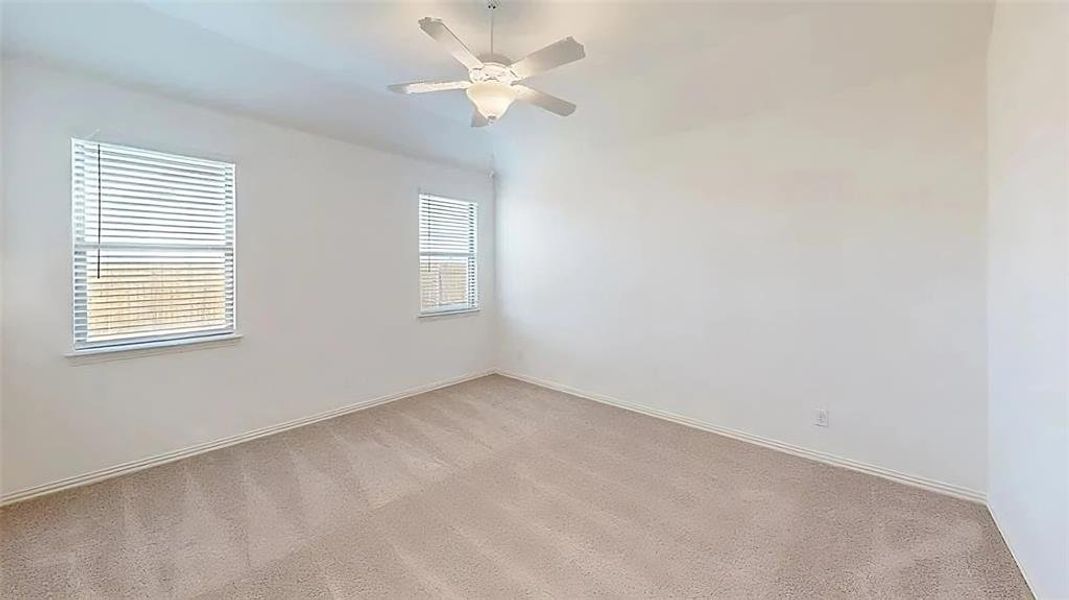 Spare room featuring carpet floors and a ceiling fan