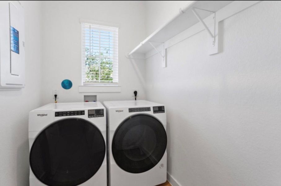 Laundry room featuring a white washer and dry set, designed for both convenience and style. Laundry room featuring a white washer and dry set, designed for both convenience and style.