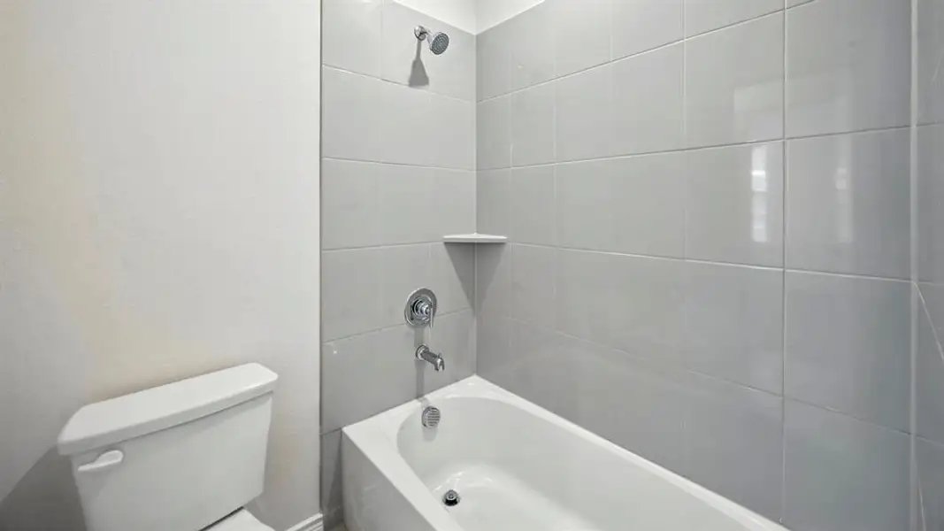 Bathroom with shower / washtub combination and toilet