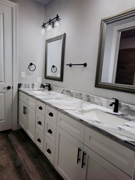 Hollywood-style bathroom with a dual-sink vanity, ample storage.