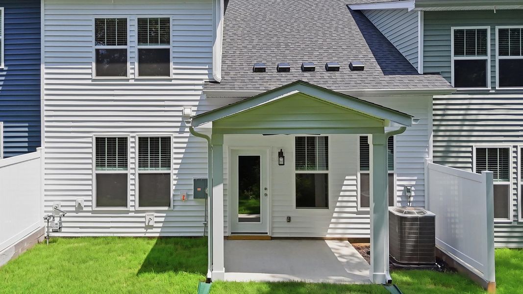 Rear covered porch creates a seamless extension of this home’s elegant design