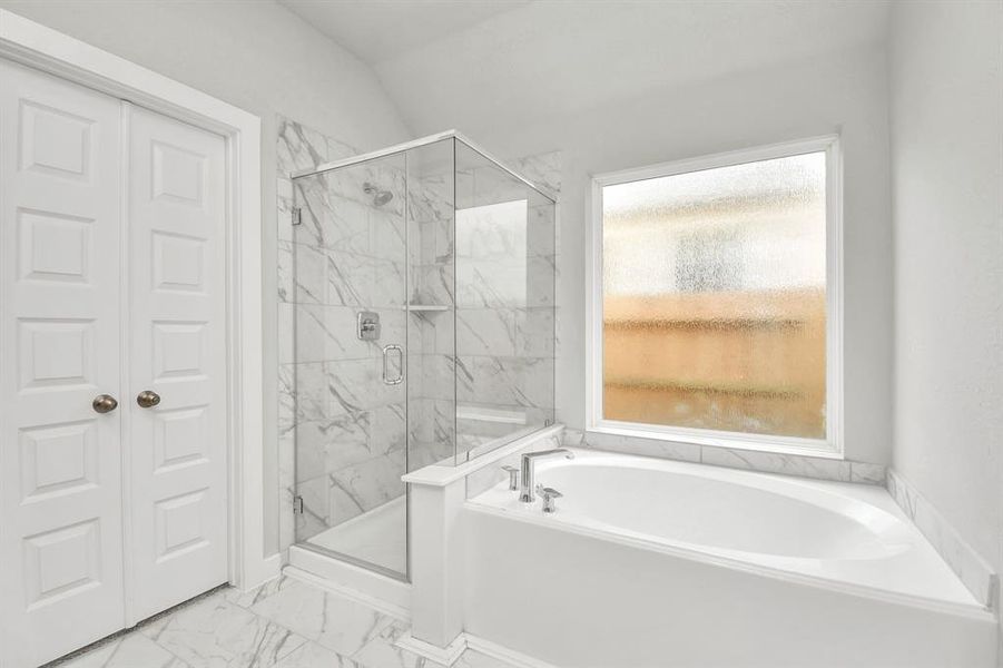 The primary en-suite has a soaking tub to give you that spa experience. The large privacy window allow lots of nature light in the space.