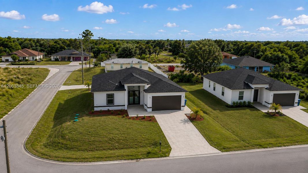 Front exterior of a new home in , Lehigh Acres, FL, highlighting curb appeal (Image 21).