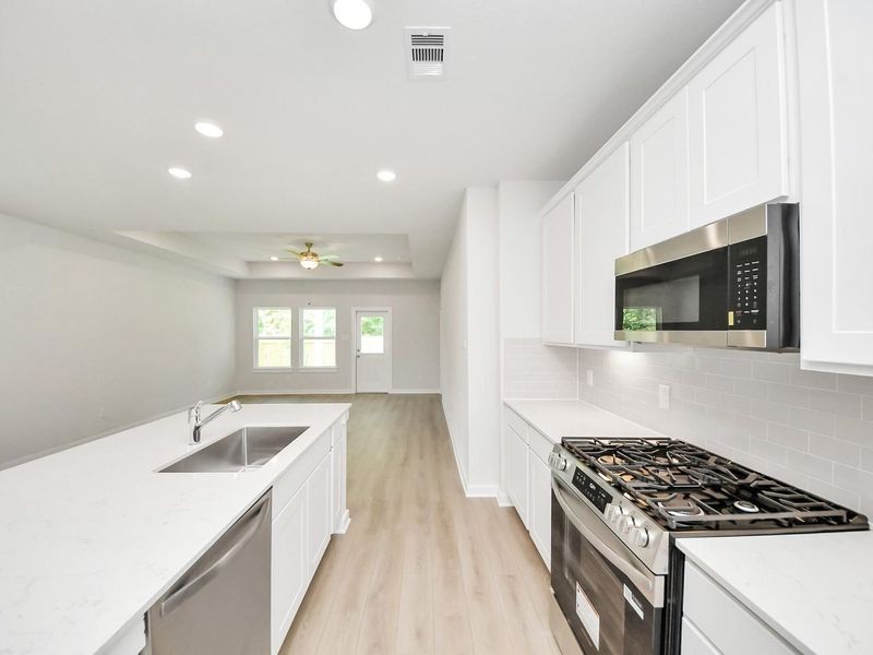 Furnished interior view inside a new home in Caney Creek Place, Conroe (Image 9).