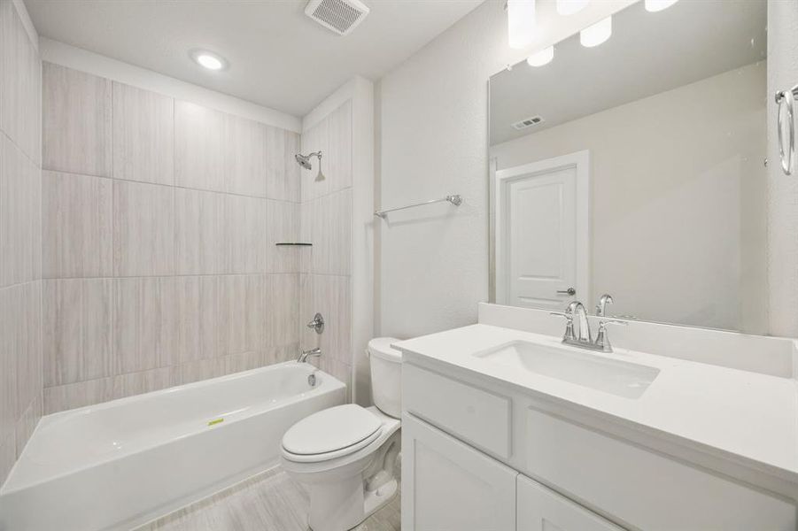 Bathroom featuring shower / bath combination and vanity